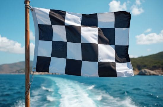 Schwarz-weiß karierte Startflagge auf einem Boot als Symbol für den Start neuer Inhalte durch einen GAIO-Freelancer.